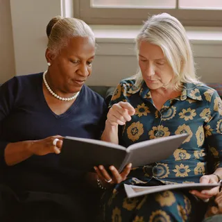 Two people looking at a plan in a folder