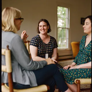 A small group talking in a living room